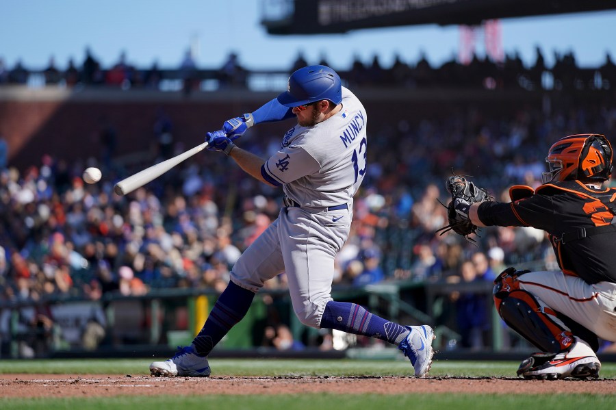 Los Angeles Dodgers' Max Muncy (13) hits a single against the San Francisco Giants during the fourth inning of a baseball game Saturday, May 22, 2021, in San Francisco. (AP Photo/Tony Avelar)