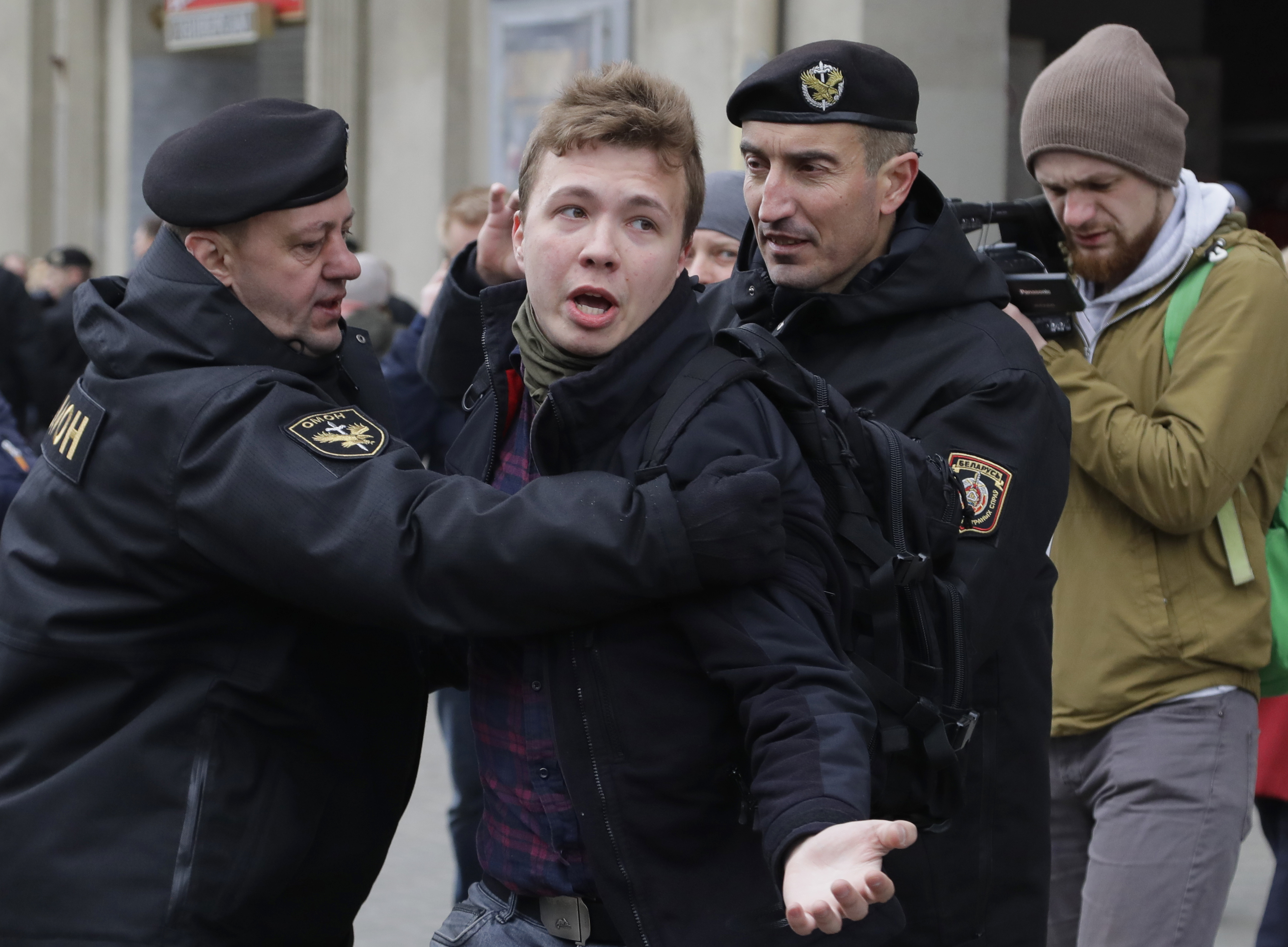 In this Sunday, March 26, 2017 file photo, Belarus police detain journalist Raman Pratasevich, center, in Minsk, Belarus. Raman Pratasevich, a founder of a messaging app channel that has been a key information conduit for opponents of Belarus’ authoritarian president, has been arrested after an airliner in which he was riding was diverted to Belarus because of a bomb threat. The presidential press service said President Alexander Lukashenko personally ordered that a MiG-29 fighter jet accompany the Ryanair plane — traveling from Athens, Greece, to Vilnius, Lithuania — to the Minsk airport. ﻿﻿(AP Photo/Sergei Grits, File)