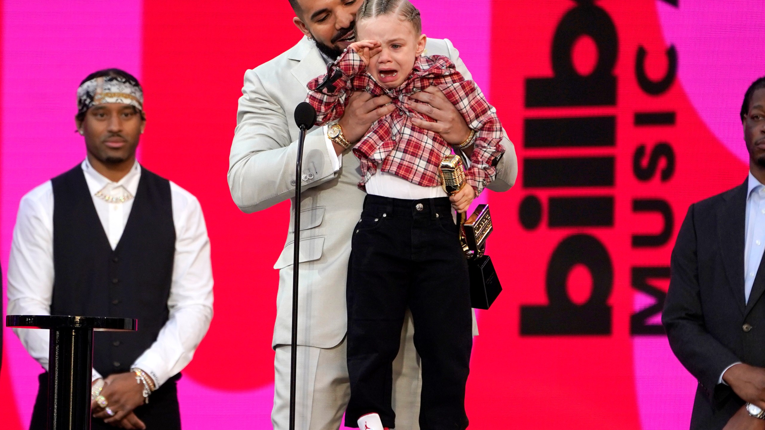 Drake carries his son Adonis Graham as he accepts the artist of the decade award at the Billboard Music Awards on Sunday, May 23, 2021, at the Microsoft Theater in Los Angeles. (AP Photo/Chris Pizzello)