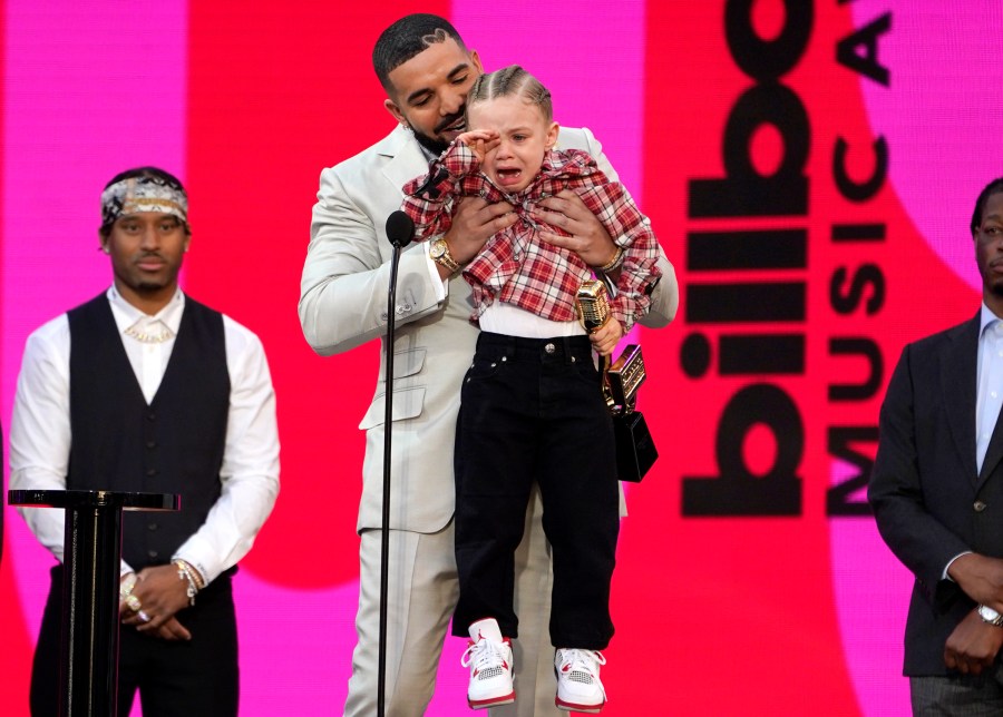 Drake carries his son Adonis Graham as he accepts the artist of the decade award at the Billboard Music Awards on Sunday, May 23, 2021, at the Microsoft Theater in Los Angeles. (AP Photo/Chris Pizzello)