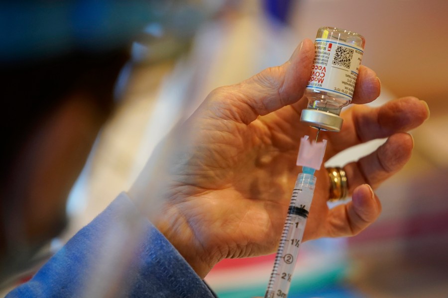 In this Dec. 29, 2020, file photo, Pat Moore, with the Chester County, Pa., Health Department, fills a syringe with Moderna COVID-19 vaccine before administering it to emergency medical workers and health care personnel at the Chester County Government Services Center in West Chester, Pa. (AP Photo/Matt Slocum, File)