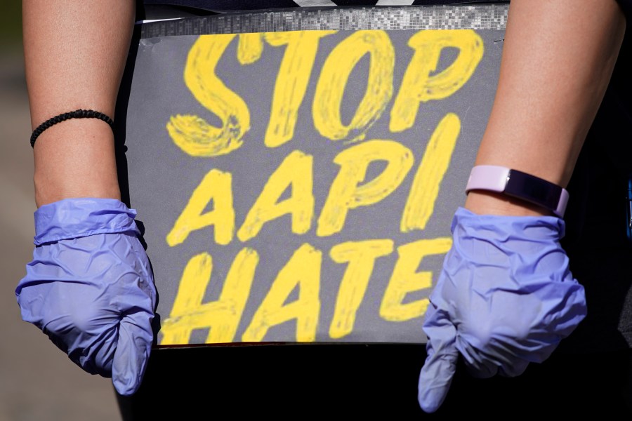 In this March 20, 2021, file photo, woman holds a sign and attends a rally to support stop AAPI hate at the Logan Square Monument in Chicago. (Nam Y. Huh/Associated Press)