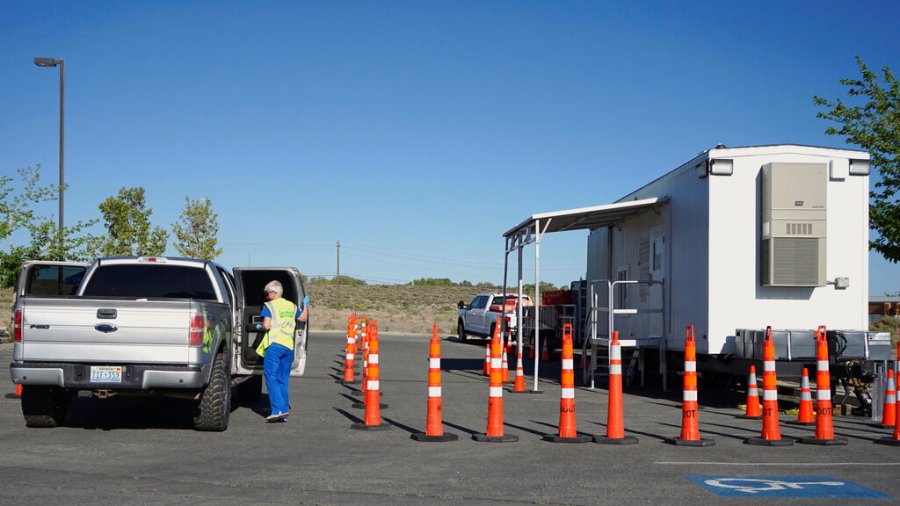 Peggy Franklin, a volunteer nurse from Reno, administers vaccines at a mobile vaccination clinic held at a tribal health center on the Fallon Paiute-Shoshone Reservation and Colony on May 18, 2021 in Fallon, Nev. (AP Photo/Sam Metz)