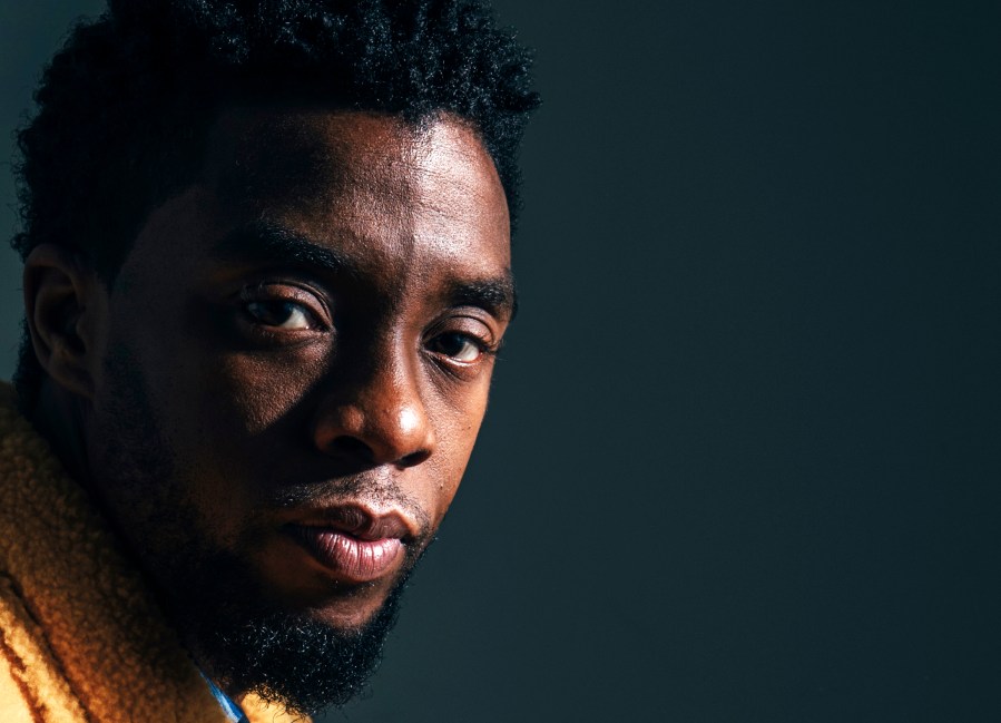 In this Feb. 14, 2018, file photo, actor Chadwick Boseman poses for a portrait in New York to promote his film, "Black Panther." The acclaimed actor is being posthumously honored as the namesake of Howard’s newly re-established Chadwick A. Boseman College of Fine Arts. Boseman, who graduated in 2000 with a BFA in directing, died in August 2020 at age 43 of colon cancer, after an illness that was largely kept secret. He rose to prominence playing a succession of Black icons in biographical films: Jackie Robinson, singer James Brown and Thurgood Marshall. (Victoria Will/Invision/AP)