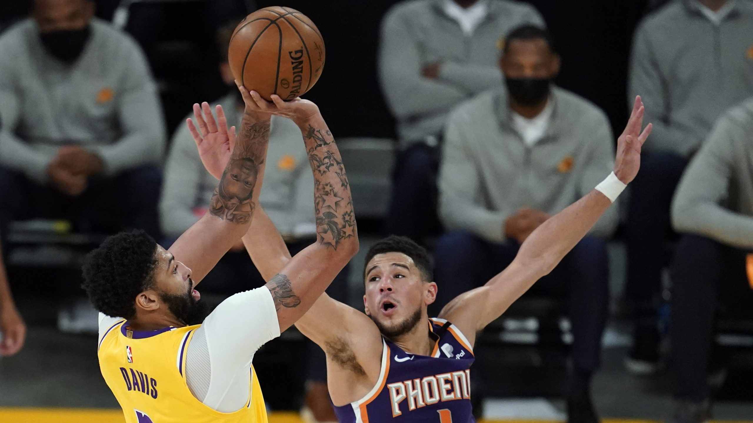 Los Angeles Lakers forward Anthony Davis shoots over Phoenix Suns guard Devin Booker during the first half in Game 3 of an NBA basketball first-round playoff series against the Phoenix Suns at Staples Center on May 27, 2021. (Marcio Jose Sanchez / Associated Press)