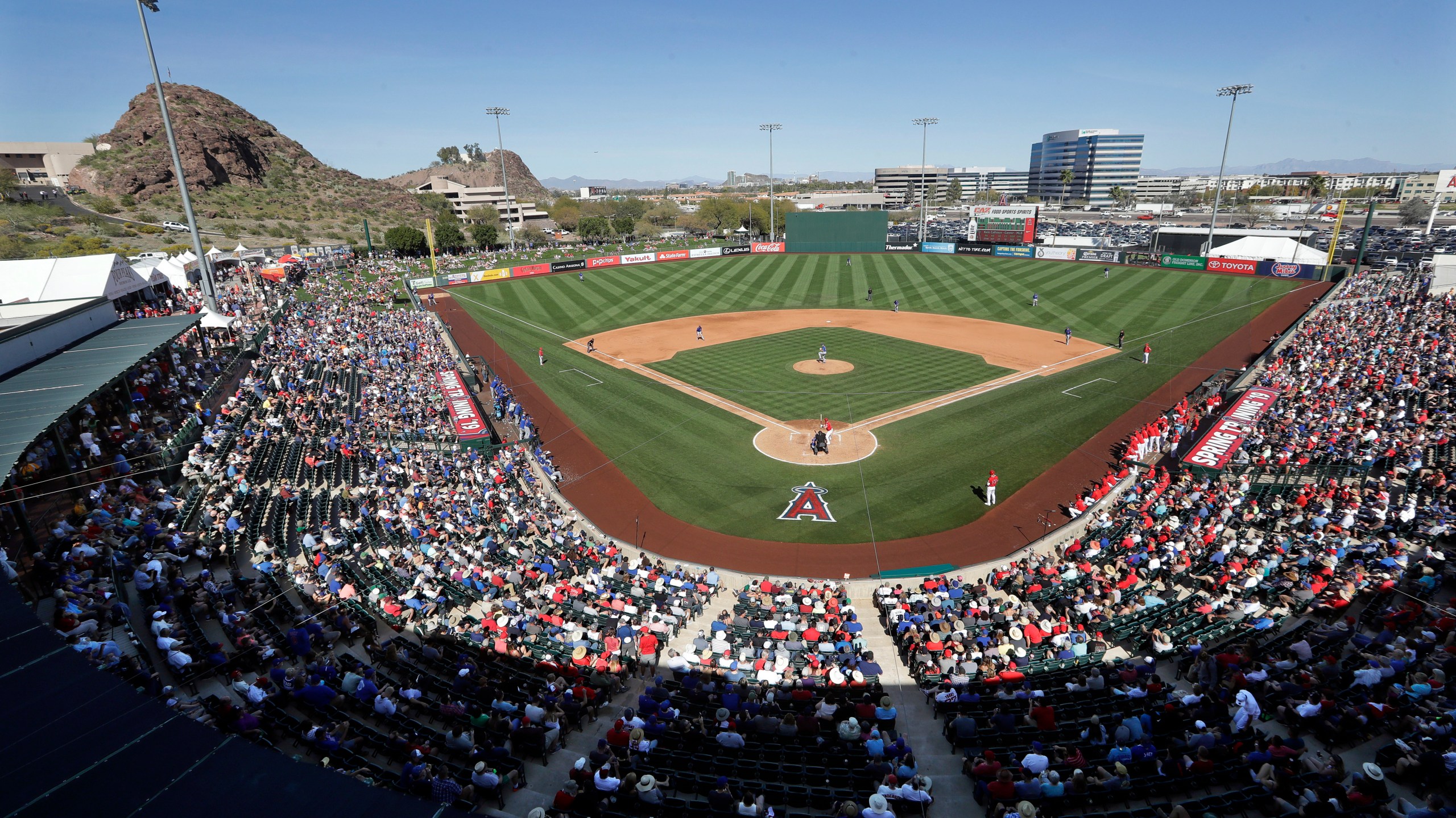 In this March 5, 2019, file photo, fans fill most of the seats at Tempe Diablo Stadium, the Los Angeles Angels' spring stadium ballpark, during the team's spring training baseball game against the Chicago Cubs in Tempe, Ariz. (AP Photo/Elaine Thompson, File)