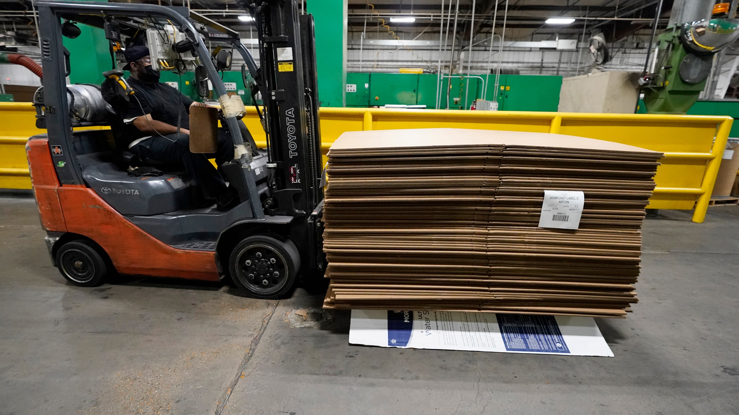 A forklift driver moves a pallet of cardboard boxes at Great Southern Industries, a packaging company in Jackson, Miss., says Friday, May 28, 2021. Charita McCarrol, human resources manager at the company, says that she has seen a lot of people abusing the $300-a-week federal supplement for people who lost their jobs during the COVID-19 pandemic, as well as other programs that offered extended support for the unemployed. She also cited the pool of needed certified and experienced forklift drivers and other positions are limited because of the said abuse. (AP Photo/Rogelio V. Solis)