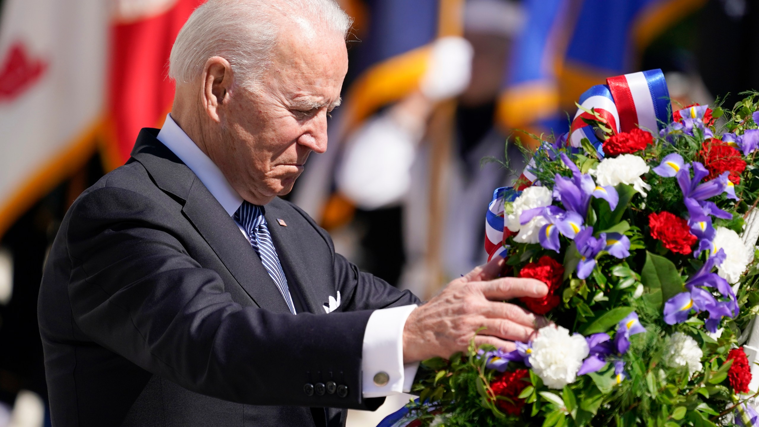 President Joe Biden adjusts a the wreath at the Tomb of the Unknown Soldier at Arlington National Cemetery on Memorial Day, Monday, May 31, 2021, in Arlington, Va.(AP Photo/Alex Brandon)