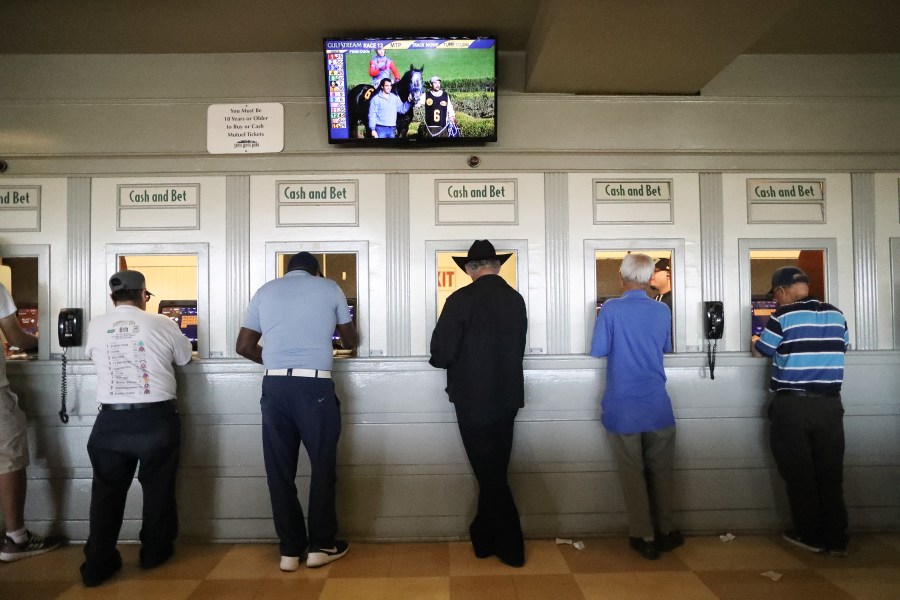 Gamblers stand at betting windows on the final day of the winter/spring horse racing season at Santa Anita Park on June 23, 2019 in Arcadia, California. (Mario Tama/Getty Images)