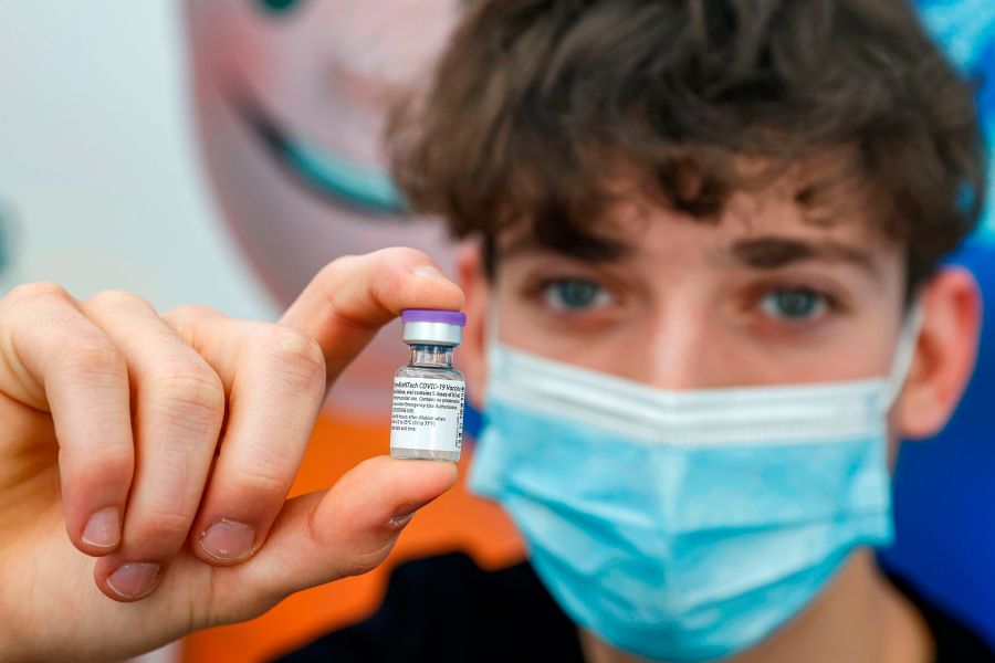 Jonathan, a 16-year-old teenager, receives a dose of the Pfizer-BioNtech COVID-19 coronavirus vaccine at Clalit Health Services, in Israel's Mediterranean coastal city of Tel Aviv on January 23, 2021. (JACK GUEZ/AFP via Getty Images)