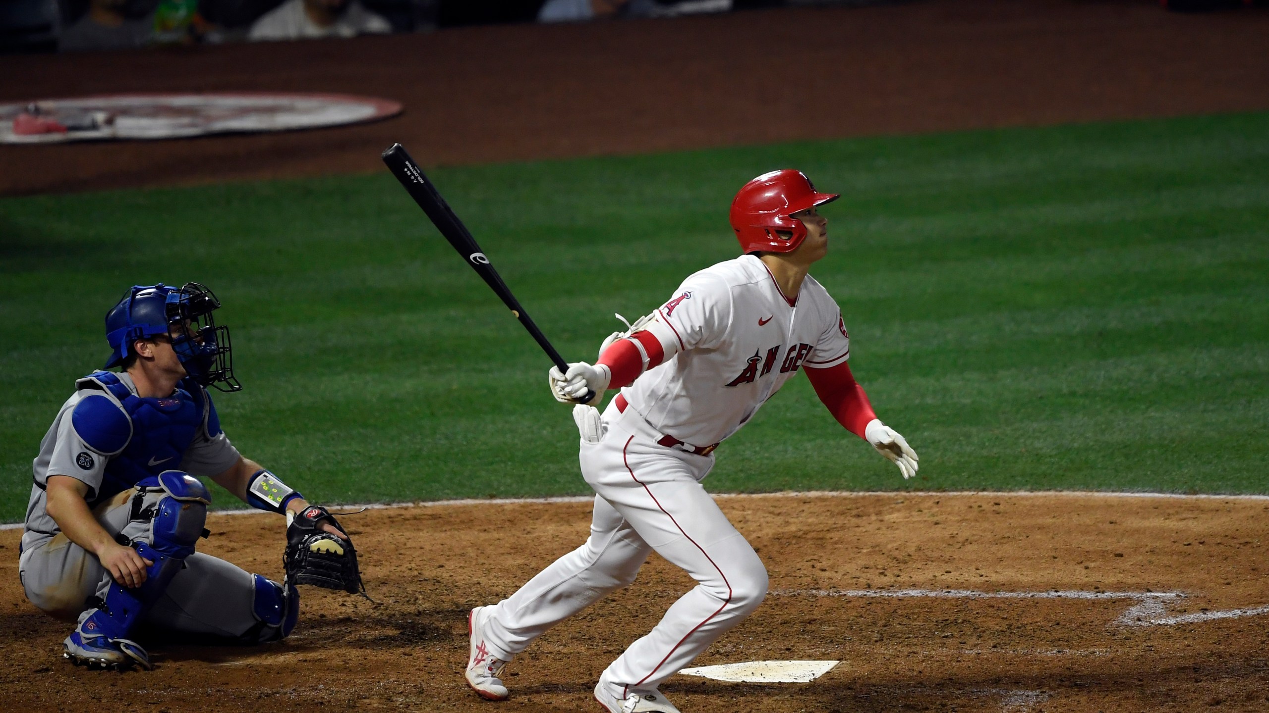 Shohei Ohtani #17 of the Los Angeles Angels hits an RBI double to score David Fletcher #22 during the sixth inning against relief pitcher Joe Kelly #17 of the Los Angeles Dodgers at Angel Stadium in Anaheim on May 7, 2021. (Kevork Djansezian / Getty Images)