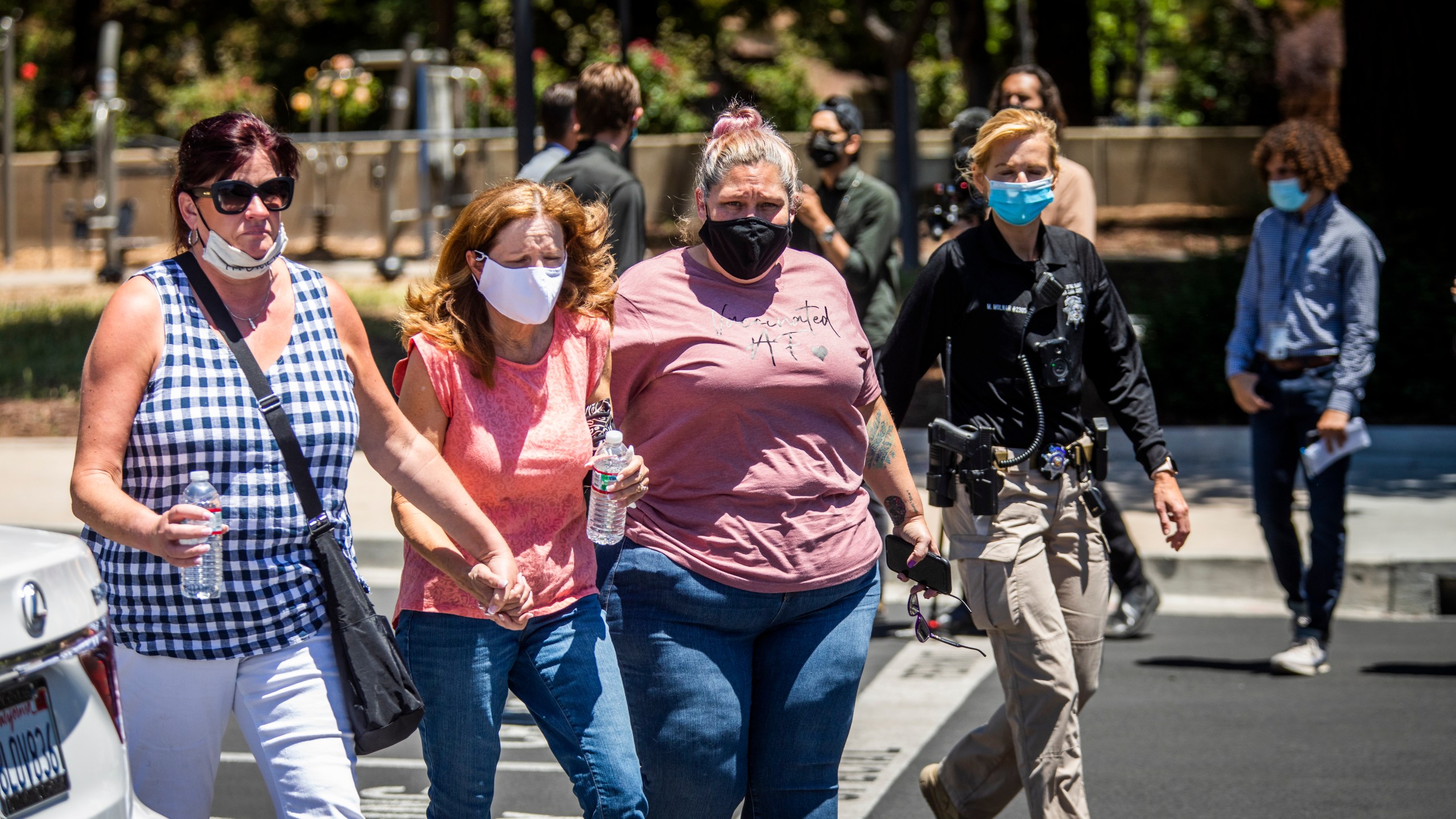 People leave a gathering point for family members and VTA employees on May 26, 2021, in San Jose, Calif. A VTA employee opened fire at the yard, with preliminary reports indicating nine people dead including the gunman. (Philip Pacheco/Getty Images)