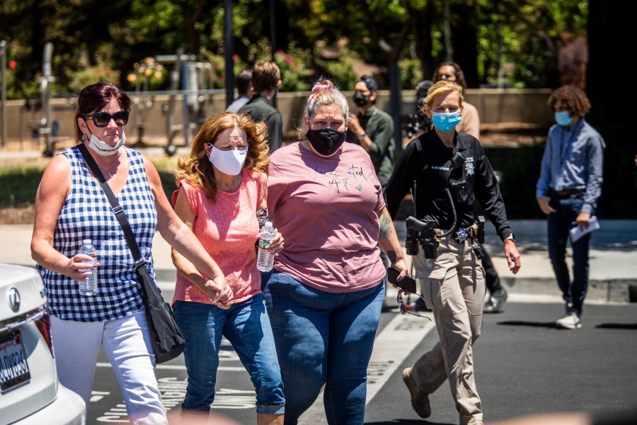 People leave a gathering point for family members and VTA employees on May 26, 2021, in San Jose, Calif. A VTA employee opened fire at the yard, with preliminary reports indicating nine people dead including the gunman. (Philip Pacheco/Getty Images)