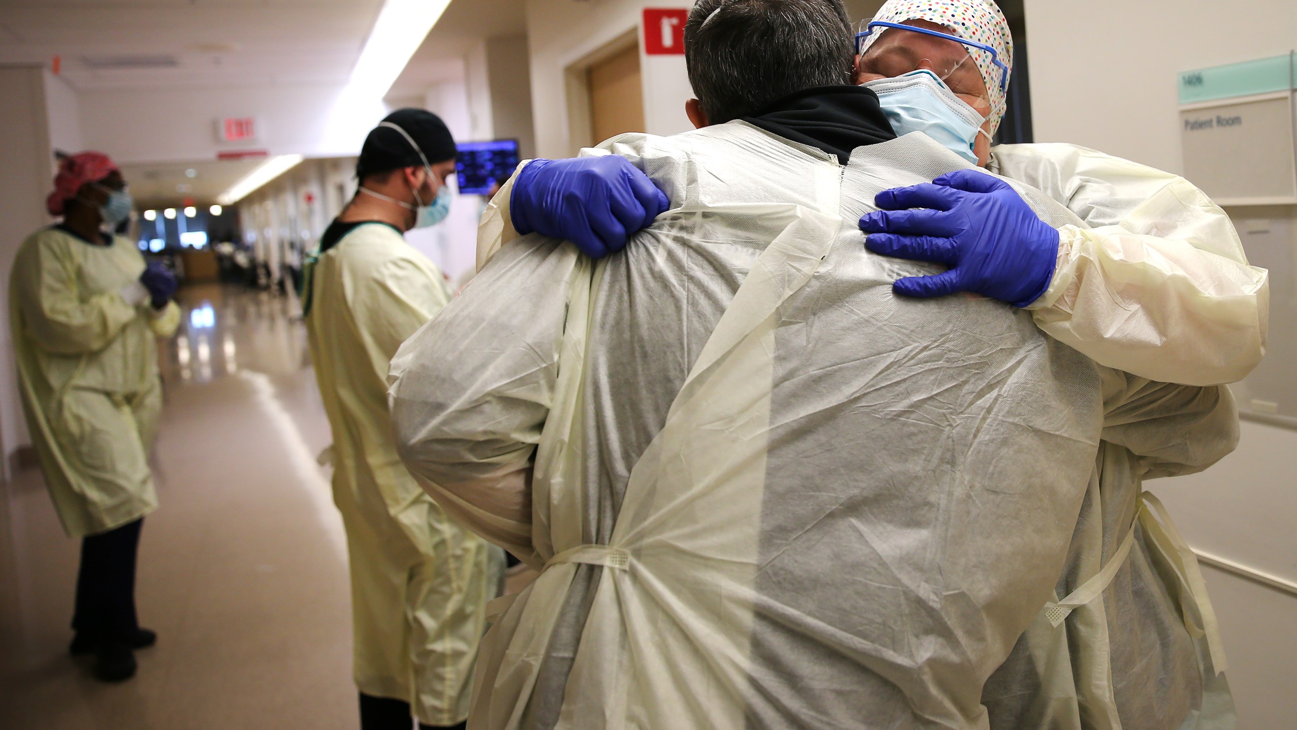 Chaplain Kevin Deegan hugs registered nurse Connie Carrillo at Providence Holy Cross Medical Center in the Mission Hills neighborhood in Los Angeles on Feb. 17, 2021. (Mario Tama / Getty Images)