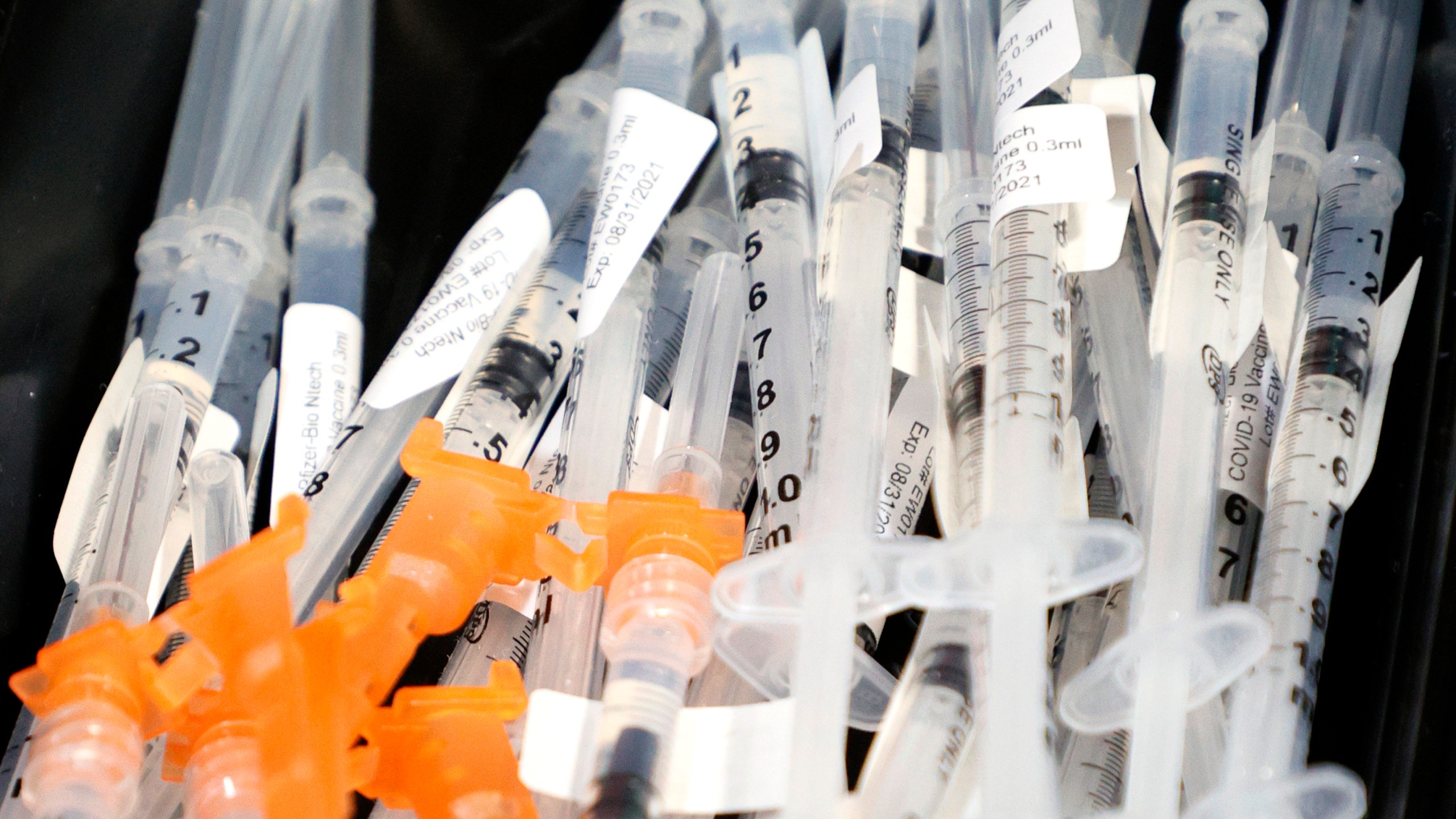 Syringes with the Pfizer-BioNTech COVID-19 vaccine are placed on a tray at a pop-up COVID-19 vaccination clinic at Larry Flynt's Hustler Club on May 21, 2021 in Las Vegas, Nevada. (Ethan Miller/Getty Images)