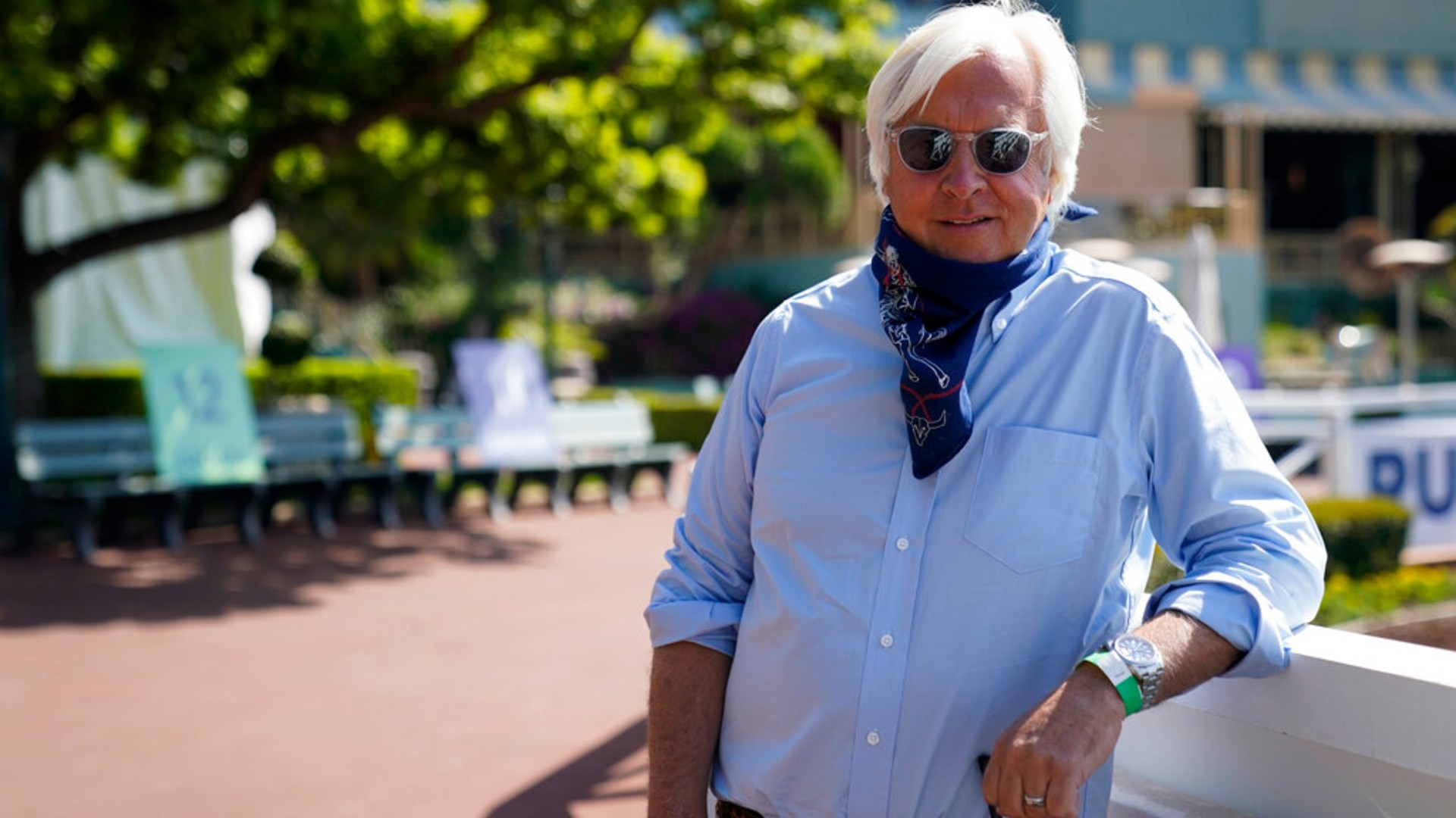 In this May 22, 2020, file photo, Bob Baffert, two-time Triple Crown-winning trainer, lowers his bandana during an interview while keeping his distance at Santa Anita Park in Arcadia, Calif. (AP Photo/Ashley Landis, File)