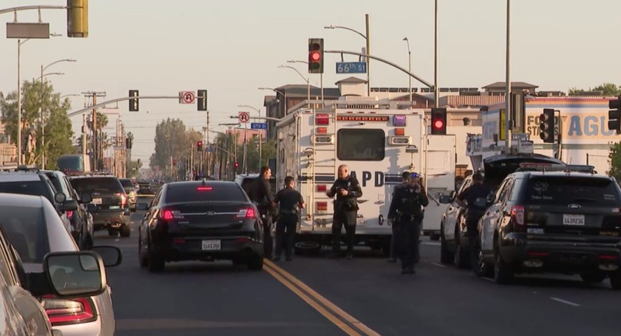 Investigators appear at the scene of a shooting involving a homicide suspect and Ontario police officers in the Florence neighborhood of South Los Angeles on May 4, 2021. (KTLA)