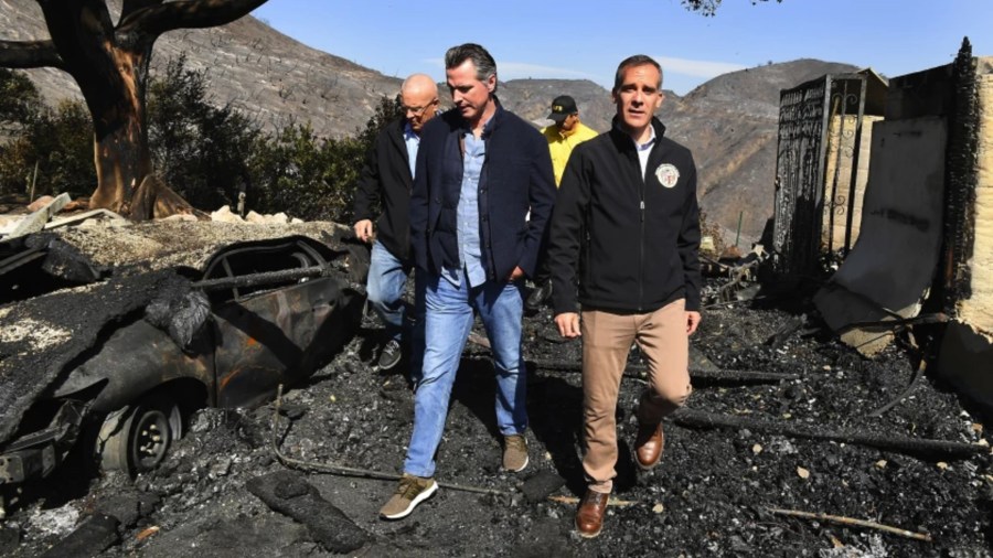 Gov. Gavin Newsom, center, looks over fire devastation in Brentwood with L.A. Mayor Eric Garcetti, right, and others in 2019.(Wally Skalij / Los Angeles Times)