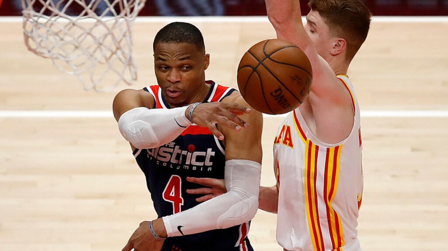 Washington Wizards' Russell Westbrook, left, passes away from Atlanta Hawks' Kevin Huerter in the second half of an NBA basketball game Monday, May 10, 2021, in Atlanta. (AP Photo/Ben Margot)