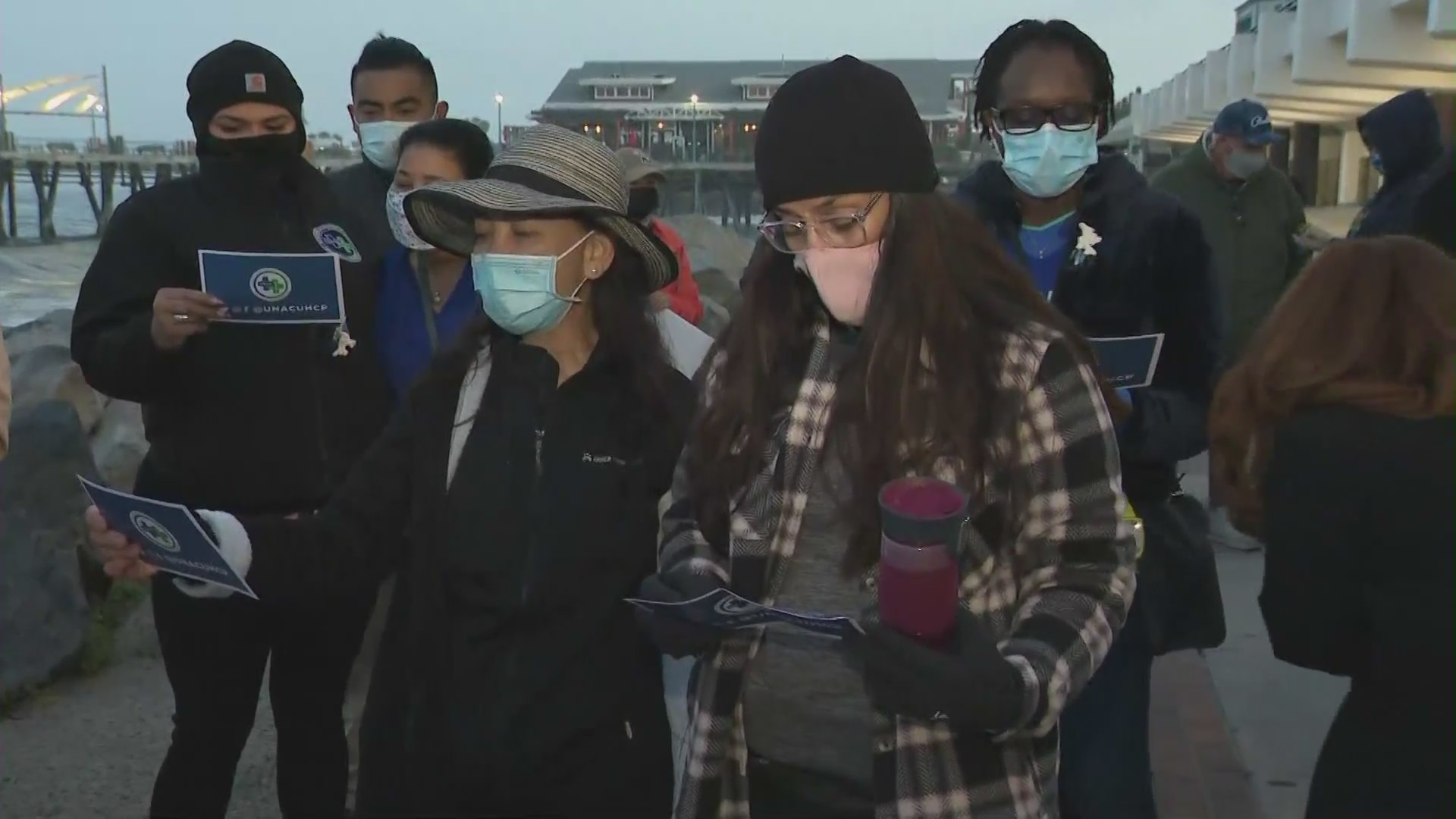 Health care workers hold vigil for those who died of COVID at Redondo Beach Pier on May 22, 2021. (KTLA)