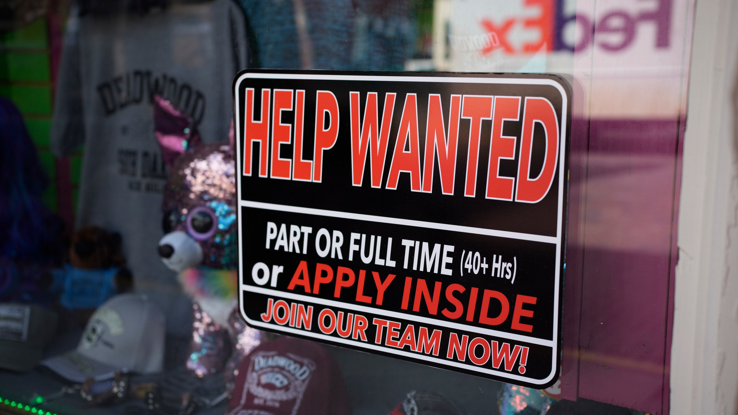 In this May 26, 2021 photo, a sign for workers hangs in the window of a shop along Main Street in Deadwood, S.D. U.S. employers added 559,000 jobs in May, an improvement from April’s sluggish gain but still evidence that many companies are struggling to find enough workers as the economy rapidly recovers from the pandemic recession. (AP Photo/David Zalubowski)