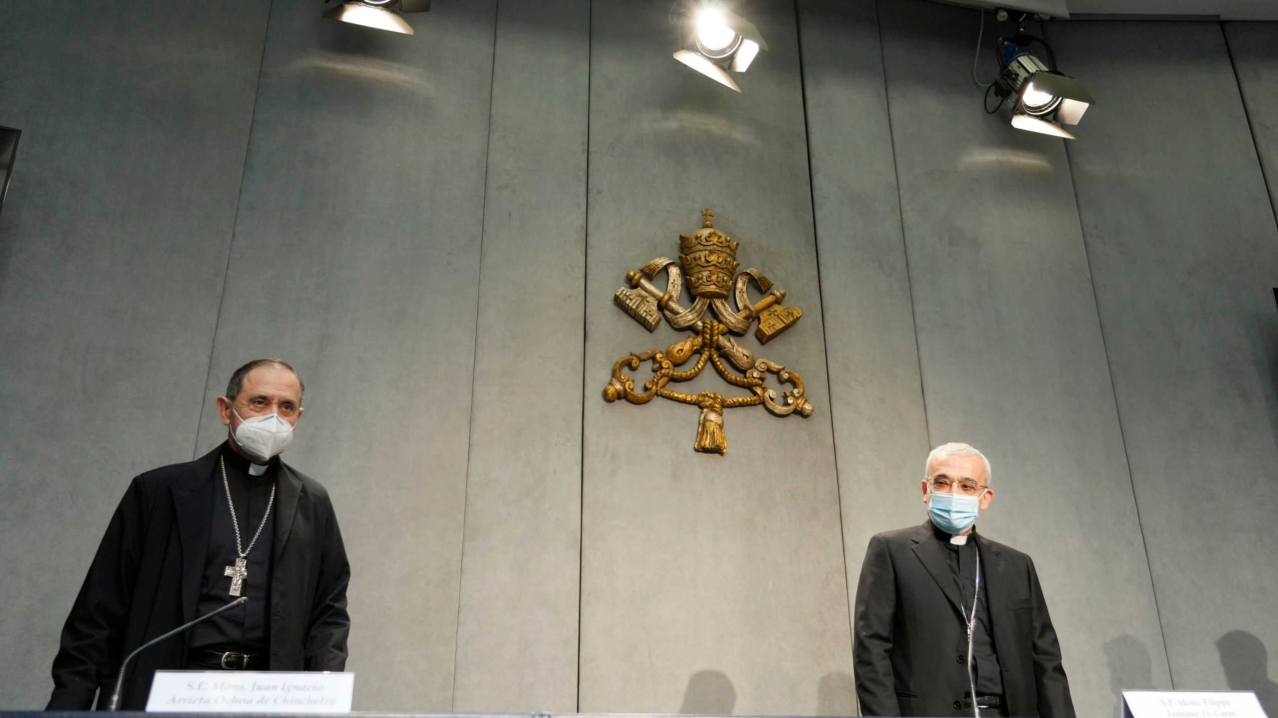 Mons. Filippo Iannone, right, and Mons. Juan Ignacio Arrieta Ochoa de Chinchetru arrive for a press conference to illustrate changes in the Church's Canon law, at the Vatican, Tuesday, June 1, 2021. Pope Francis has changed church law to explicitly criminalize the sexual abuse of adults by priests who abuse their authority and to say that laypeople who hold church office can be sanctioned for similar sex crimes. (AP Photo/Andrew Medichini)