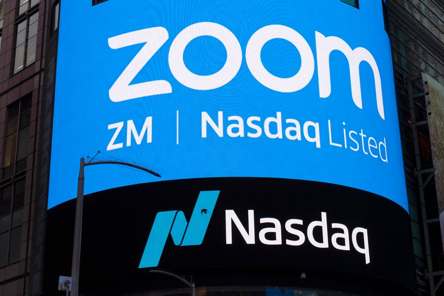 This April 18, 2019, file photo shows a sign for Zoom Video Communications ahead of their Nasdaq IPO in New York. (AP Photo/Mark Lennihan, File)