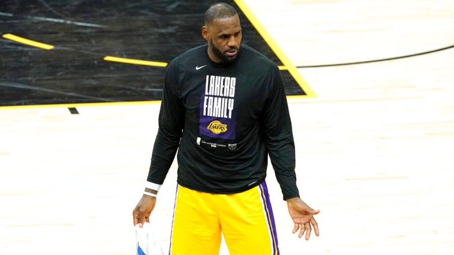 Los Angeles Lakers forward LeBron James speaks to his teammates on the bench during the second half of Game 5 of an NBA basketball first-round playoff series against the Phoenix Suns, Tuesday, June 1, 2021, in Phoenix. (AP Photo/Matt York)