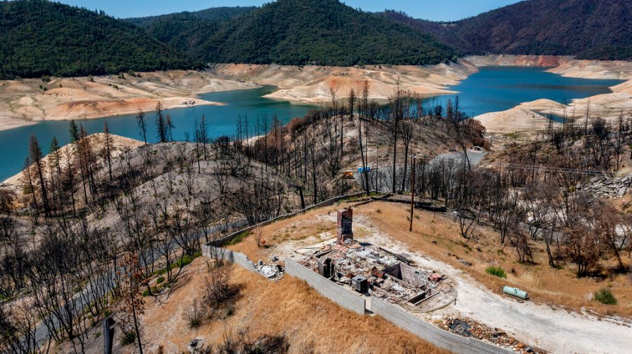 A home destroyed in the 2020 North Complex Fire sits above Lake Oroville on Sunday, May 23, 2021, in Oroville, Calif. (AP Photo/Noah Berger)