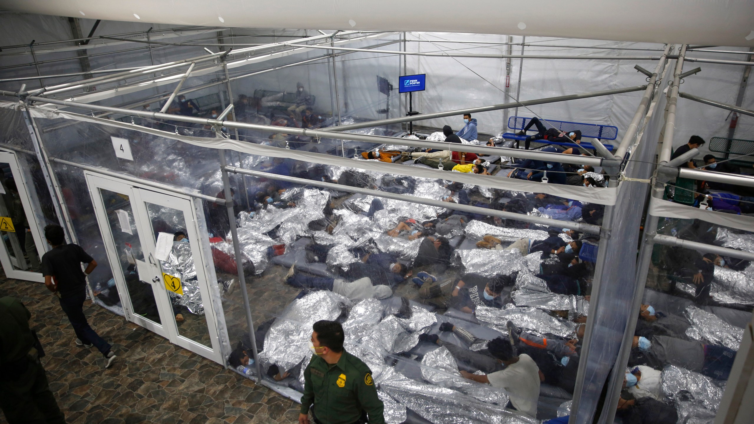 In this March 30, 2021, file photo, minors lie inside a pod at the Donna Department of Homeland Security holding facility, in Donna, Texas. A move by Texas Gov. Greg Abbott to shutter dozens of shelters housing about 4,000 migrant children is threatening to disrupt a national program offering care for minors who cross the U.S.-Mexico border. The U.S. Department of Health and Human Services said Wednesday, June 2 2021, that it didn't intend to close any facilities but that it was "assessing" the Republican governor's late Tuesday disaster declaration. (AP Photo/Dario Lopez-Mills, Pool, File)