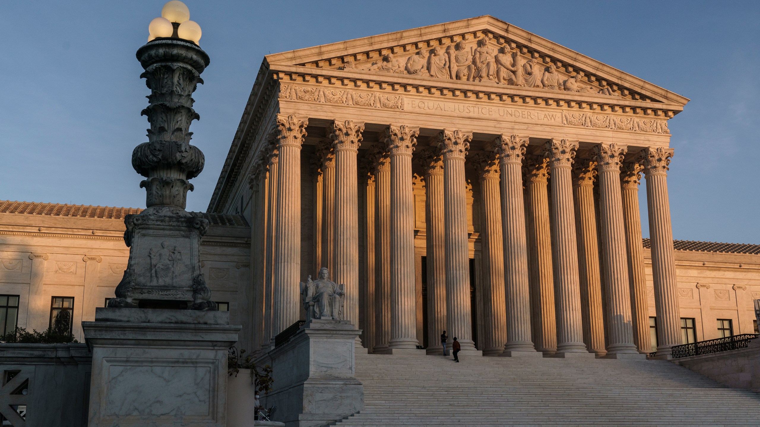 In this Nov. 6, 2020, file photo, the Supreme Court is seen at sundown in Washington. The state of California has agreed to pay more than $2 million in legal fees in a settlement with churches that challenged coronavirus closure orders. Church lawyers who successfully took their appeal to the U.S. Supreme Court said Wednesday, June 2, 2021, that the state agreed not to impose restrictions on houses of worship that are greater than those on retail businesses. (AP Photo/J. Scott Applewhite, File)