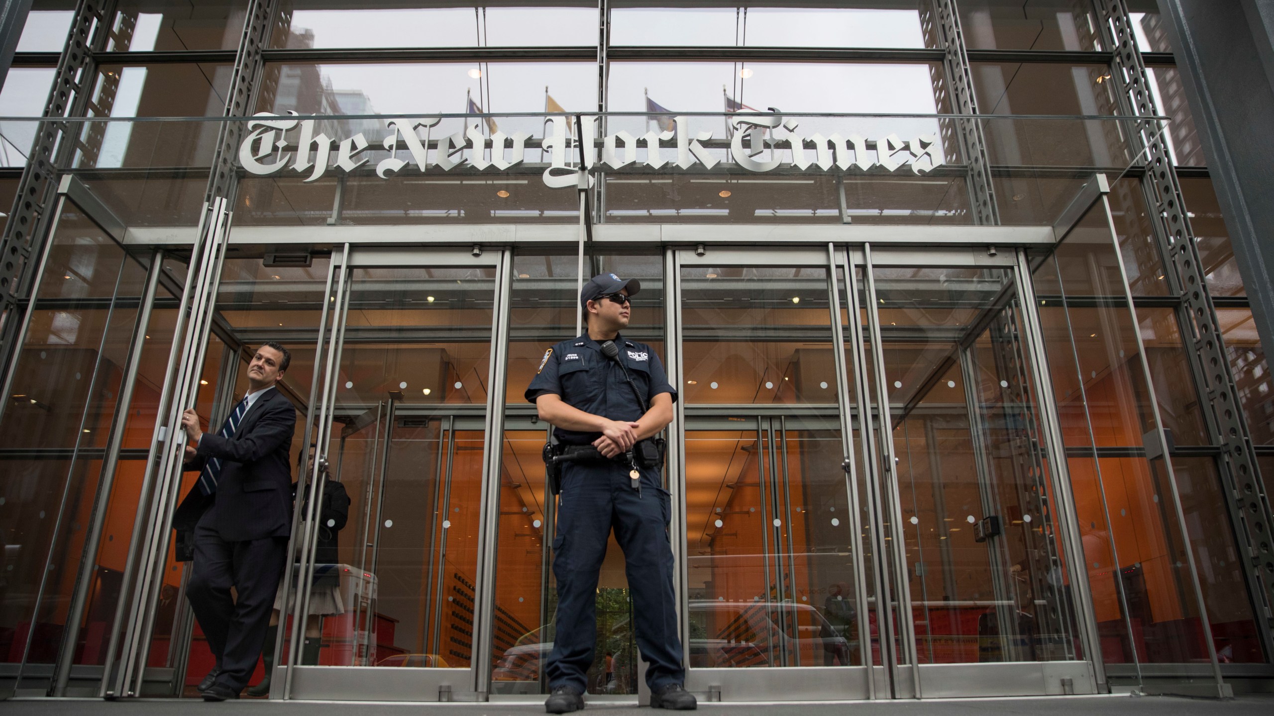 In this June 28, 2018, file photo, a police officer stands outside The New York Times building in New York. The Trump Justice Department secretly obtained the phone records of four New York Times journalists as part of a leak investigation, the newspaper said Wednesday, June 2, 2021. (AP Photo/Mary Altaffer, File)