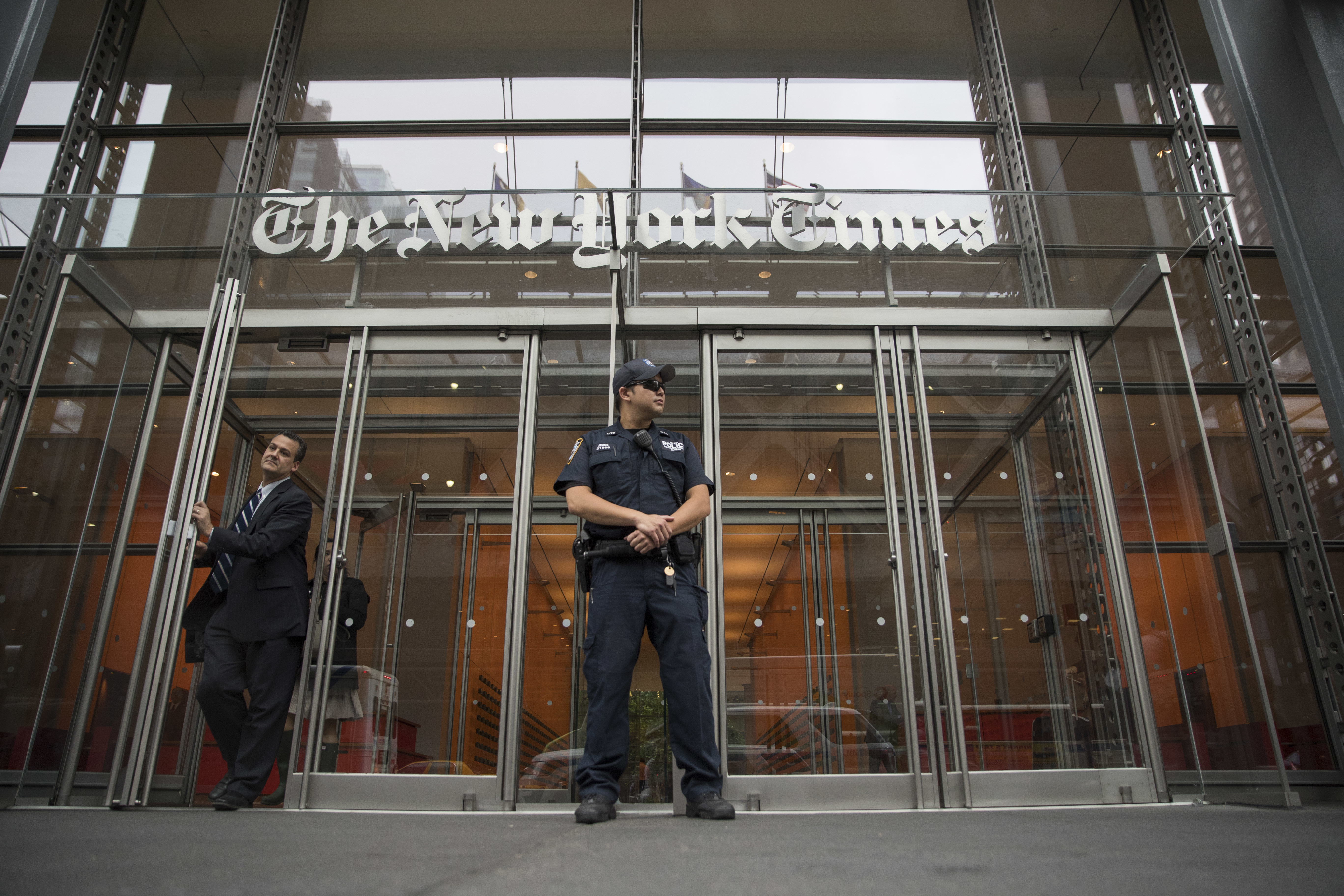 In this June 28, 2018, file photo, a police officer stands outside The New York Times building in New York. The Trump Justice Department secretly obtained the phone records of four New York Times journalists as part of a leak investigation, the newspaper said Wednesday, June 2, 2021. (AP Photo/Mary Altaffer, File)