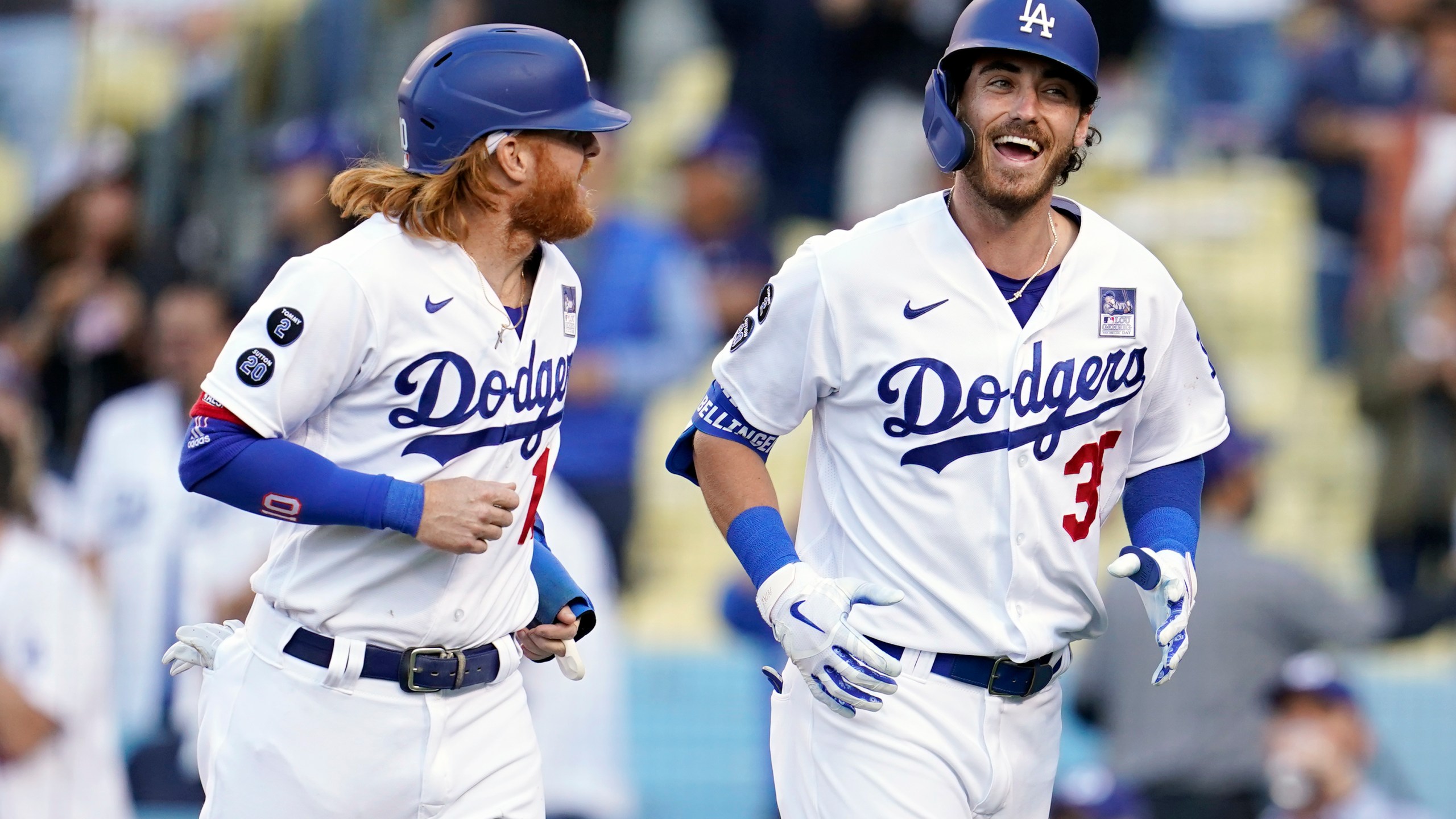 Los Angeles Dodgers' Cody Bellinger, right, smiles next to Justin Turner after Bellinger's grand slam against the St. Louis Cardinals during the first inning of a baseball game on June 2, 2021, in Los Angeles. (AP Photo/Marcio Jose Sanchez)