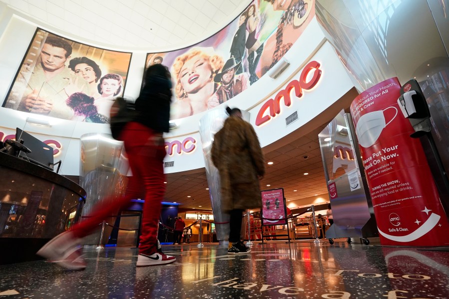 In this March 15, 2021, file photo movie patrons arrive to see a film at the AMC 16 theater in Burbank, Calif. AMC is looking to sell up to 11.5 million of its shares, as the movie theater operator looks to capitalize on its meme stock popularity. The announcement in a regulatory filing on Thursday, June 3 comes just two days after the company said it was raising $230.5 million through an 8.5 million share sale. (AP Photo/Mark J. Terrill, File)