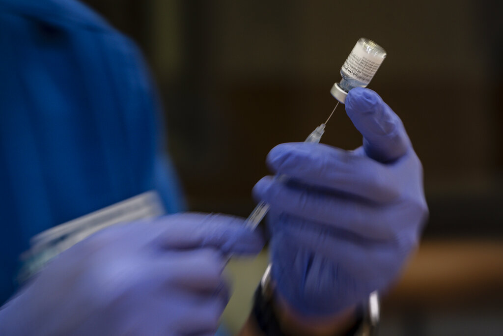 Odessa College nursing student Moon Suk Kim prepares doses of the Pfizer COVID-19 vaccine for use in a vaccination clinic hosted by Odessa College Thursday, June 3, 2021 in Odessa, Texas. (Eli Hartman/Odessa American via AP)