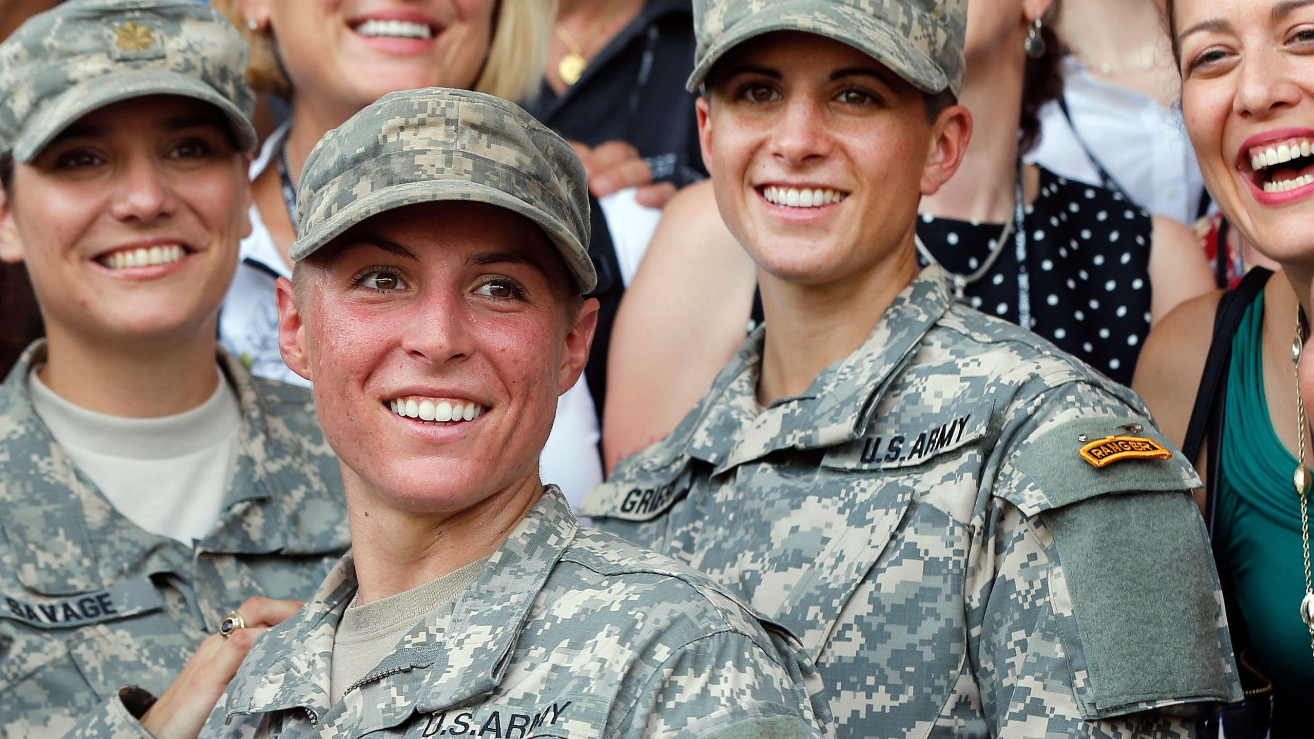 In this Aug. 21, 2015, file photo, Army 1st Lt. Shaye Haver, center, and Capt. Kristen Griest, right, pose for photos with other female West Point alumni after an Army Ranger school graduation ceremony at Fort Benning, Ga. Haver and Griest became the first female graduates of the Army's rigorous Ranger School. (AP Photo/John Bazemore, File)