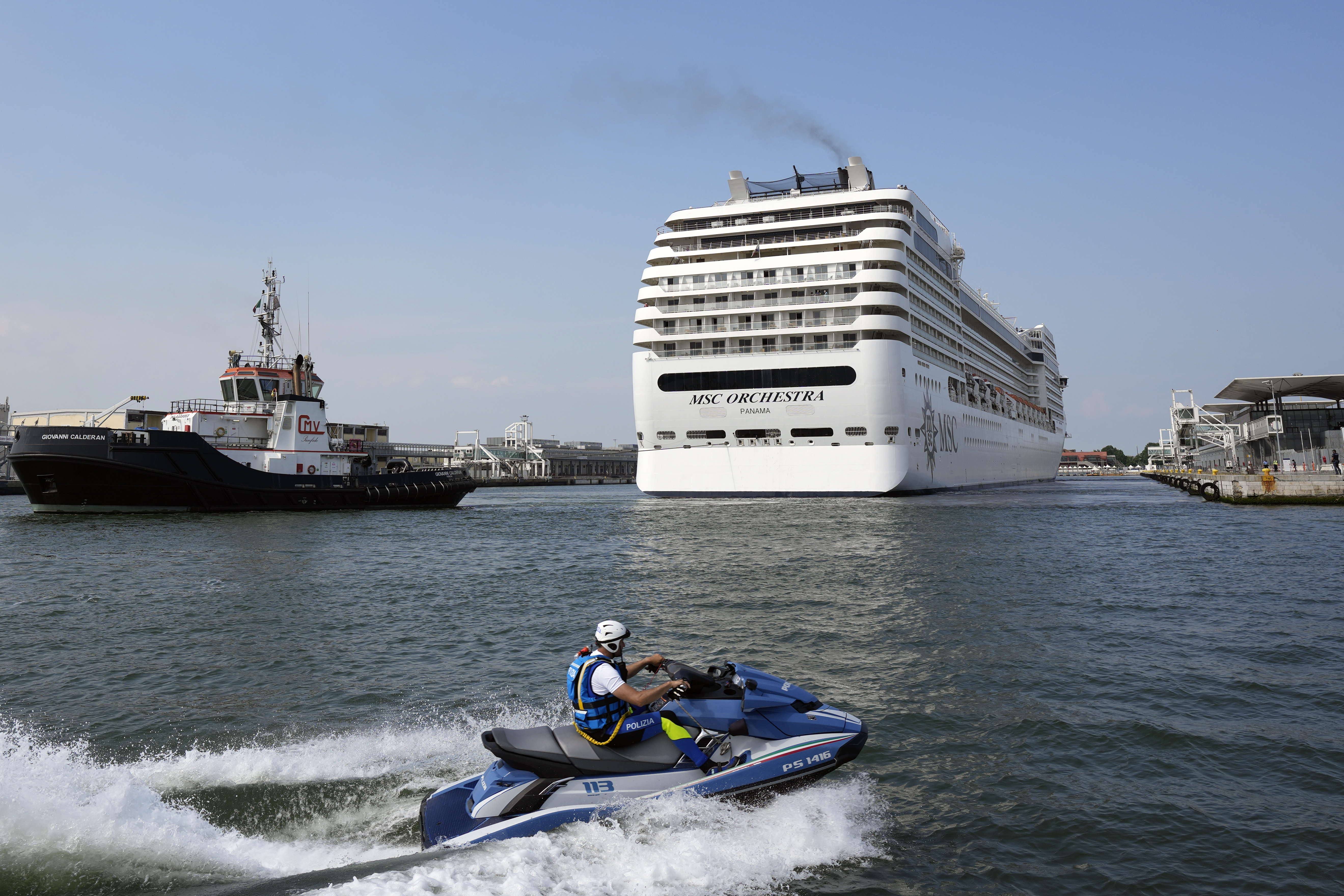 The the 92,409-ton, 16-deck MSC Orchestra cruise ship exits the lagoon as it leaves Venice, Italy, Saturday, June 5, 2021. (AP Photo/Antonio Calanni)