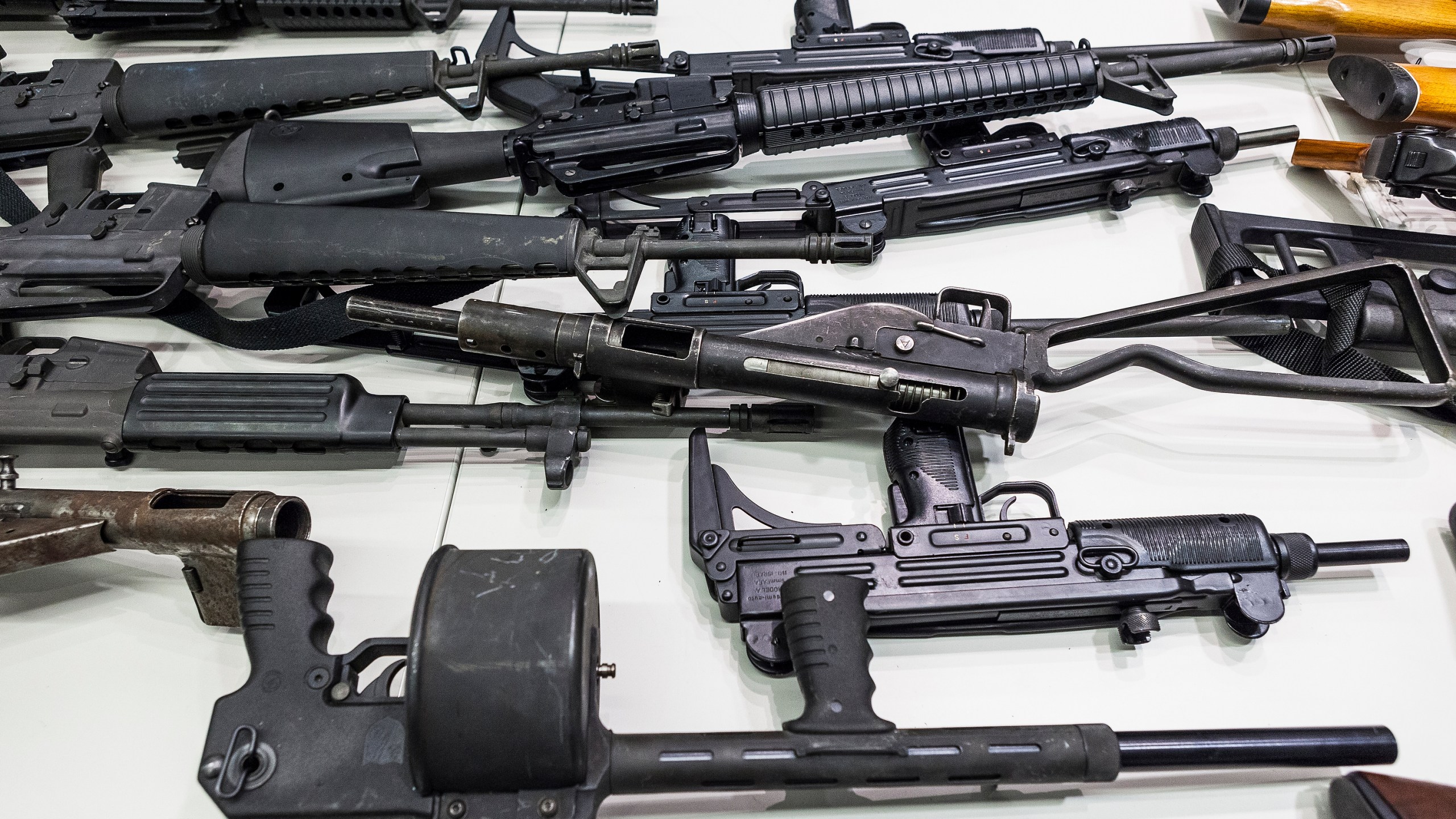 In this Dec. 27, 2012, file photo are some of the weapons that include handguns, rifles, shotguns and assault weapons, collected in a Los Angeles Gun Buyback event displayed during a news conference at the LAPD headquarters in Los Angeles. A federal judge has overturned California's three-decade-old ban on assault weapons, ruling that it violates the constitutional right to bear arms. U.S. District Judge Roger Benitez of San Diego ruled Friday, June 4, 2021, that the state's definition of illegal military-style rifles unlawfully deprives law-abiding Californians of weapons commonly allowed in most other states. (AP Photo/Damian Dovarganes, File)