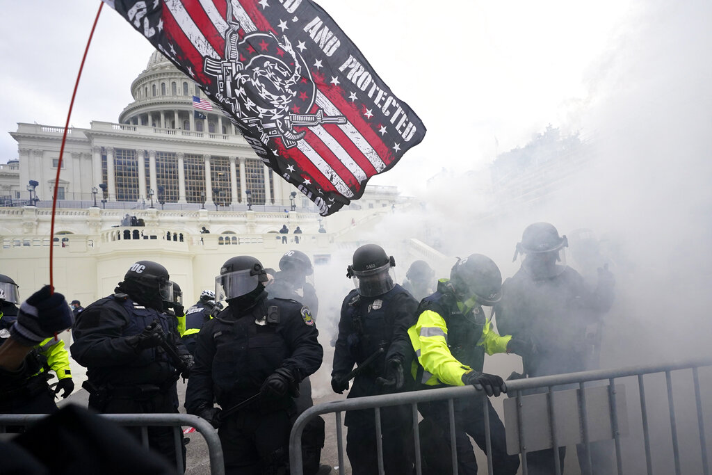 In this Jan. 6, 2021, U.S. Capitol Police officers hold off rioters loyal to President Donald Trump at the Capitol in Washington. (AP Photo/Julio Cortez, File)