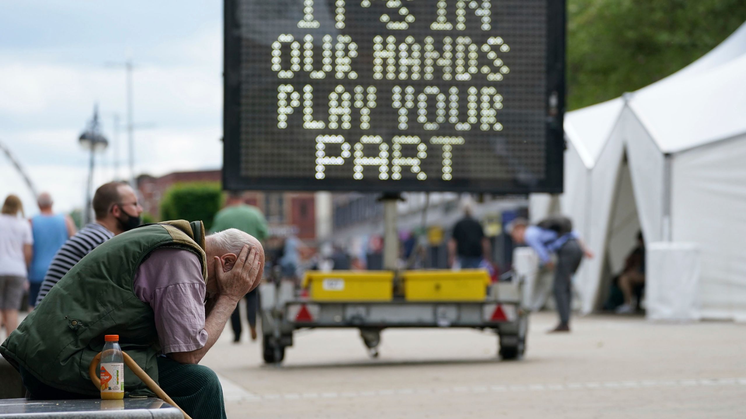 A man waits outside a mobile COVID-19 vaccination centre outside Bolton Town Hall, in Bolton, England, Wednesday, June 9, 2021, where case numbers of the Delta variant first identified in India have been relatively high. (Peter Byrne/PA via AP)