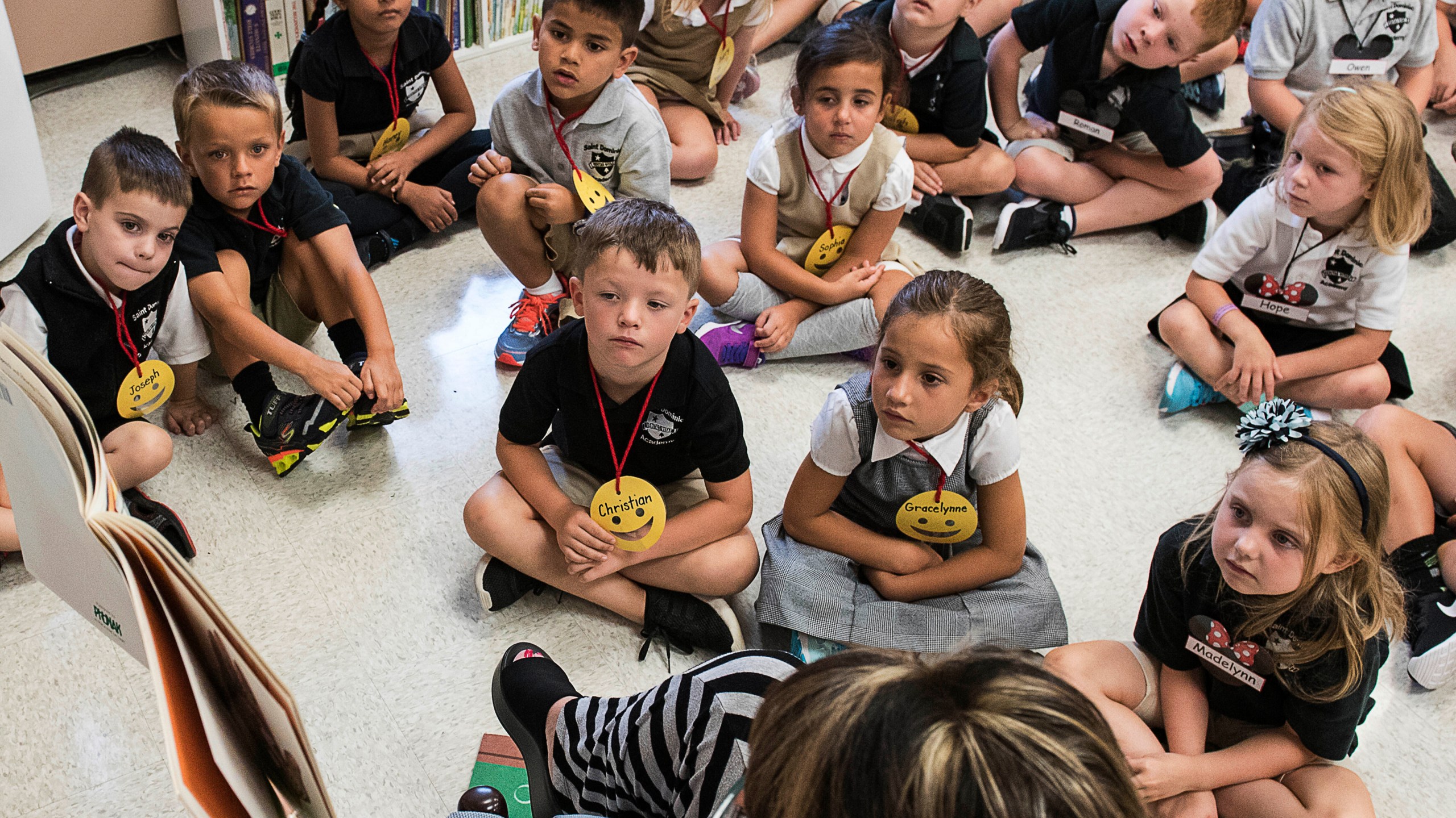 In this Aug. 22, 2018, file photo, students from two kindergarten classes at the Lewiston elementary campus of Saint Dominic Academy, listen to a teacher read a book, in Lewiston, Maine. (Russ Dillingham/Sun Journal via AP, File)