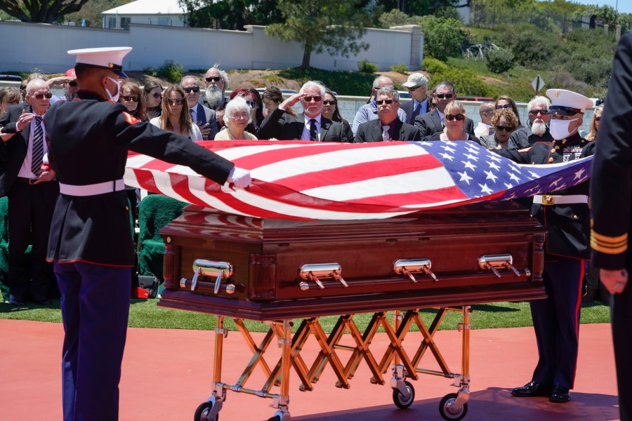 A military honor guard drapes a U.S. flag over the casket of Marine Corps, Pfc. John Franklin Middleswart for a full military honors at Fort Rosecrans National Cemetery, Tuesday, June 8, 2021 in San Diego. Eighty years after he died in the attack on Pearl Harbor and just months after his remains were finally identified, the California Marine has been laid to rest with full military honors. About 50 people attended the ceremony Tuesday for Middleswart in his hometown of San Diego, the Union-Tribune reported. (Nelvin C. Cepeda/The San Diego Union-Tribune via AP)