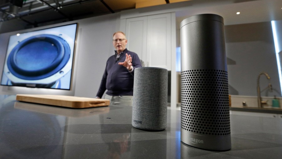 David Limp, senior vice president of Devices and Services at Amazon, displays a new Echo, left, and an Echo Plus during an event announcing several new Amazon products by the company, Wednesday, Sept. 27, 2017, in Seattle. On Tuesday, June 8, 2021 Amazon launched a program that forces users of many Echo smart speakers and Ring security cameras to automatically share a small portion of their wireless bandwidth with neighbors. The only way to stop it is to turn it off yourself. (AP Photo/Elaine Thompson)