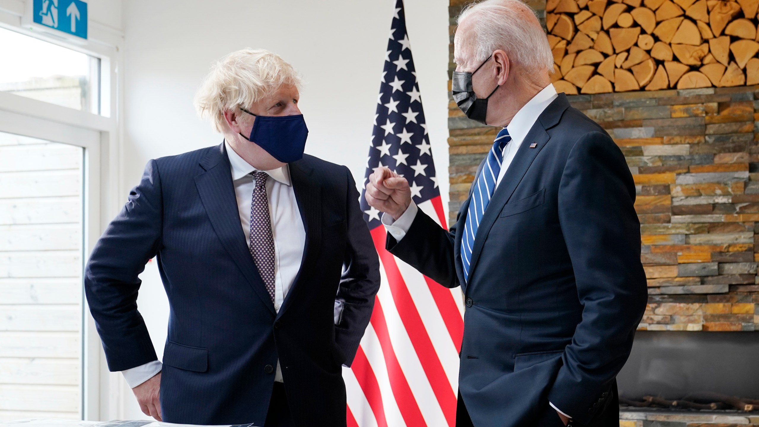 President Joe Biden and British Prime Minister Boris Johnson talk as they look over copies of the Atlantic Charter, during a bilateral meeting ahead of the G-7 summit, Thursday, June 10, 2021, in Carbis Bay, England.(AP Photo/Patrick Semansky)