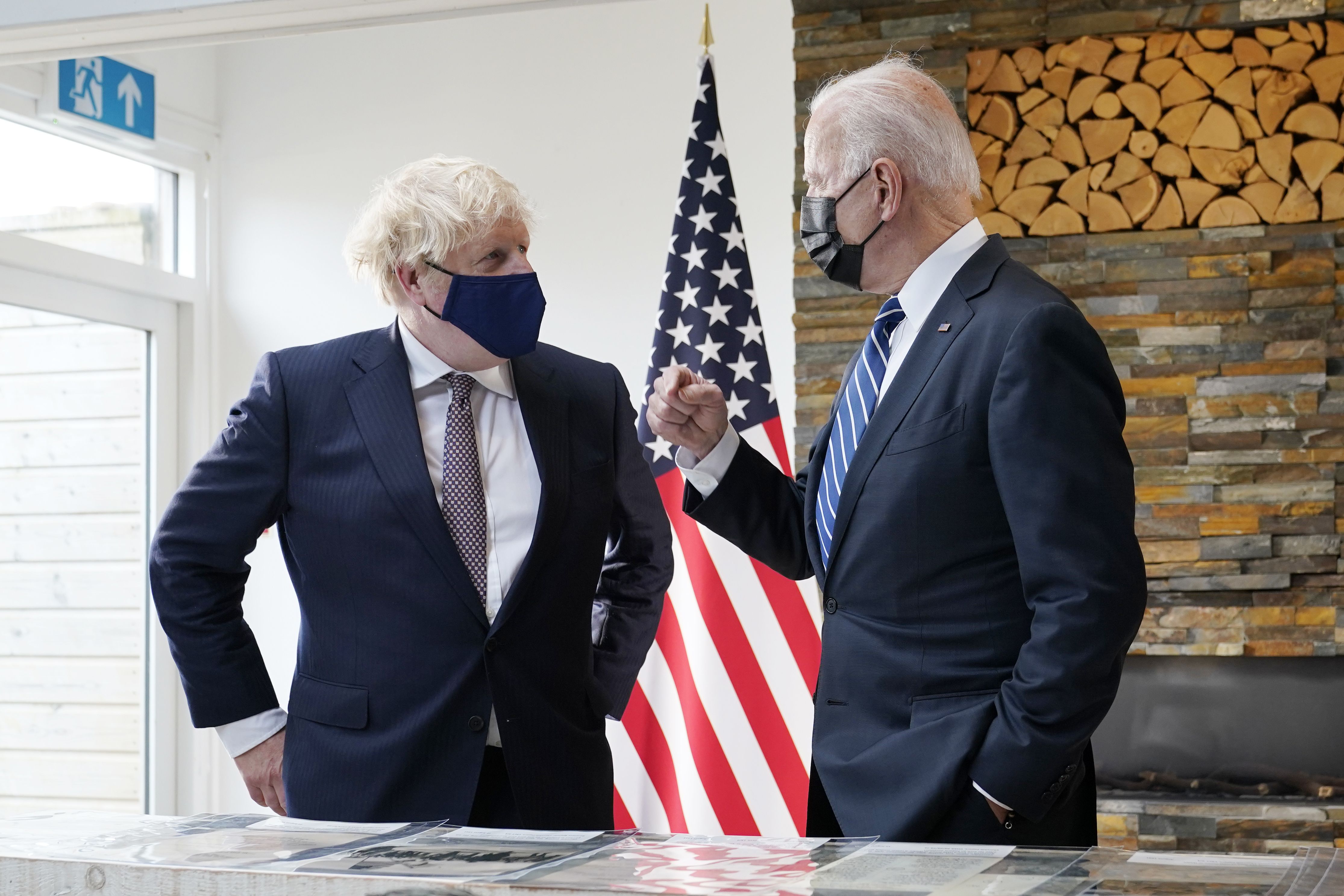 President Joe Biden and British Prime Minister Boris Johnson talk as they look over copies of the Atlantic Charter, during a bilateral meeting ahead of the G-7 summit, Thursday, June 10, 2021, in Carbis Bay, England.(AP Photo/Patrick Semansky)