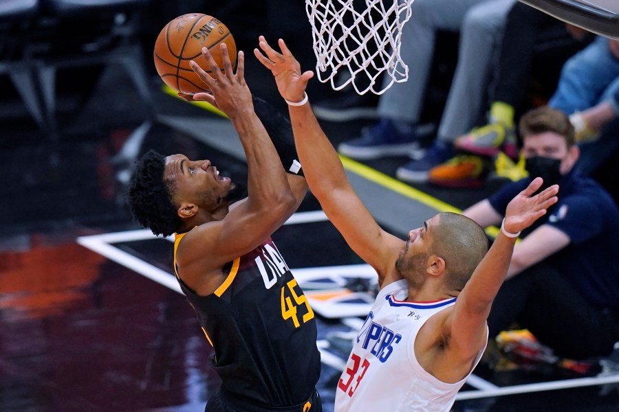 Los Angeles Clippers forward Nicolas Batum (33) defends as Utah Jazz guard Donovan Mitchell, left, goes to the basket during the first half of Game 2 of a second-round NBA basketball playoff series on June 10, 2021, in Salt Lake City. (Rick Bowmer / Associated Press)