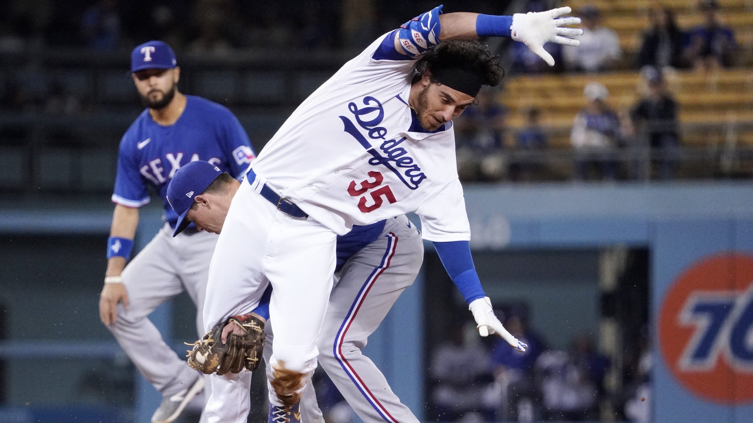 Los Angeles Dodgers' Cody Bellinger, right, is tagged out at second by Texas Rangers second baseman Nick Solak after trying to stretch a single into a double during the fourth inning of a baseball game on June 11, 2021, in Los Angeles. (Mark J. Terrill / Associated Press)