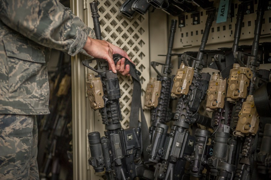 In this April 2, 2015, photo made available by the U.S. Air Force, a senior airman from the 49th Security Forces Squadron in charge of the armory, returns an M4 carbine to a rack at Holloman Air Force Base, N.M. (Airman 1st Class Aaron Montoya/U.S. Air Force via AP)