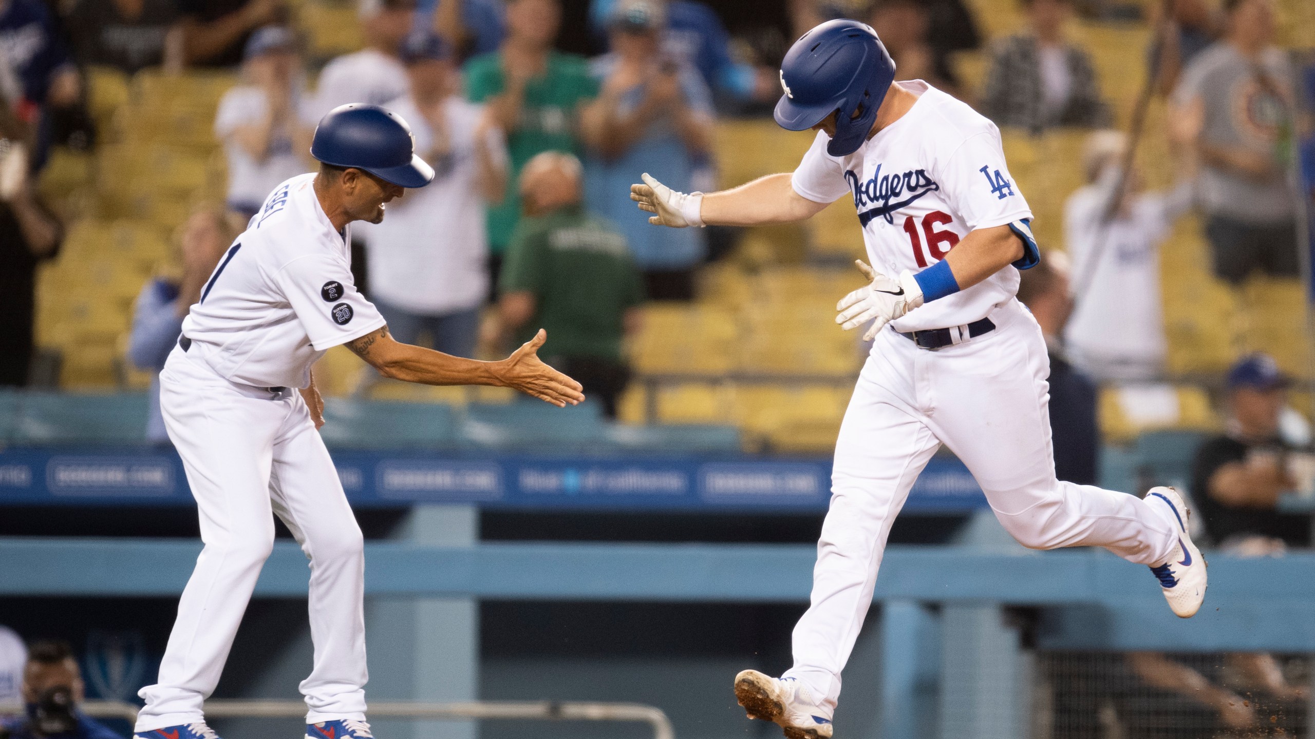 Los Angeles Dodgers' Will Smith, right, celebrates his two-run home run with third base coach Dino Ebel during the fourth inning of a baseball game against the Philadelphia Phillies in Los Angeles on June 14, 2021. (AP Photo/Kyusung Gong)